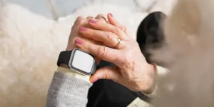 Elderly with a wearable smartwatch on wrist