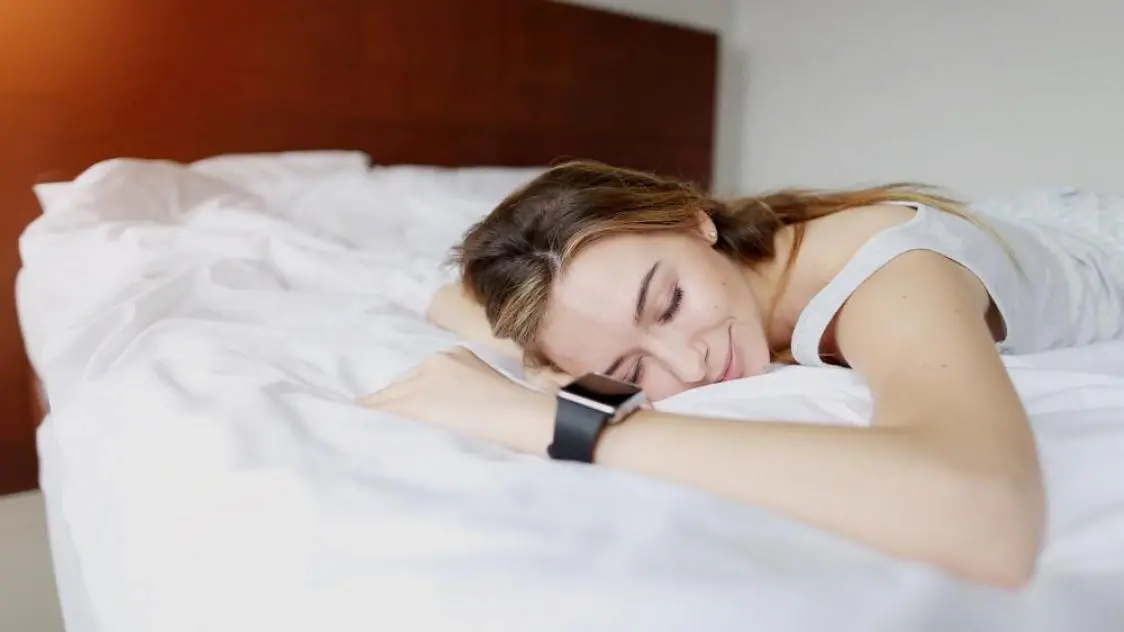 Sleeping woman with smart watch wearable